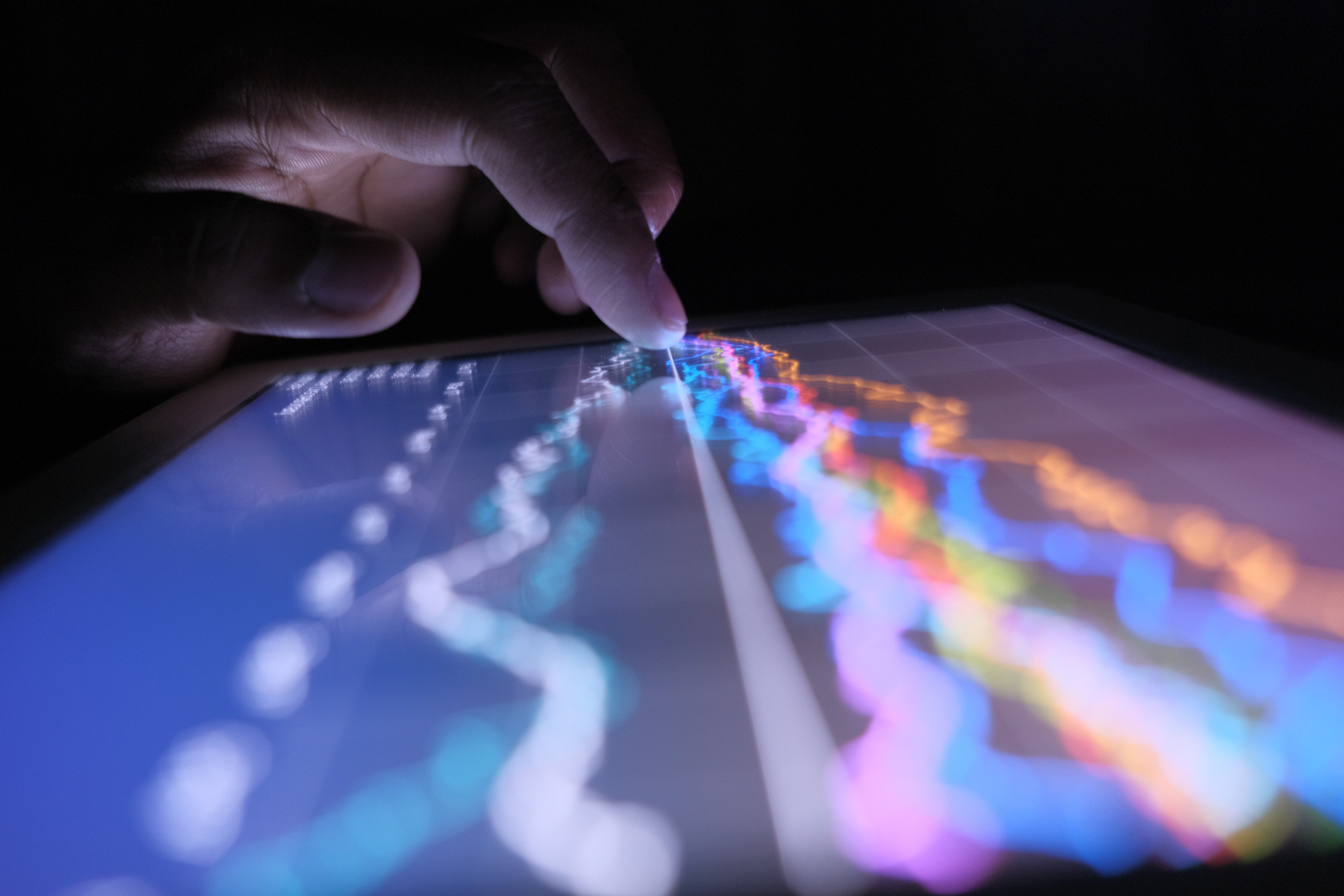 close up of man hand with digital tablet analyzing stock market graph at night